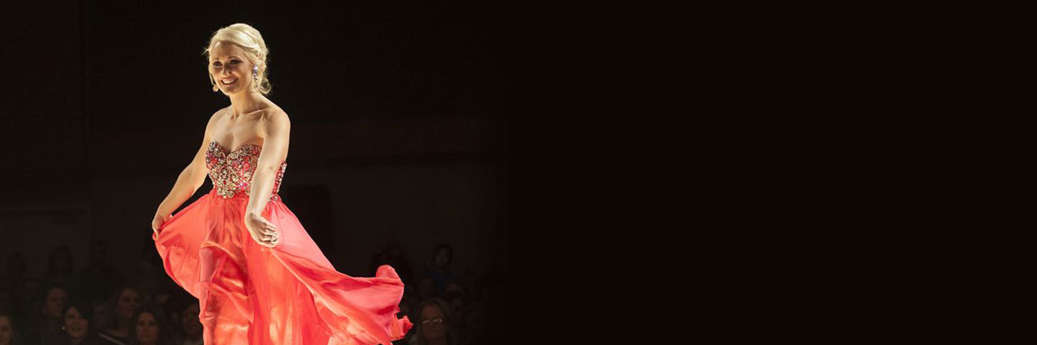 girl in orange dress on runway