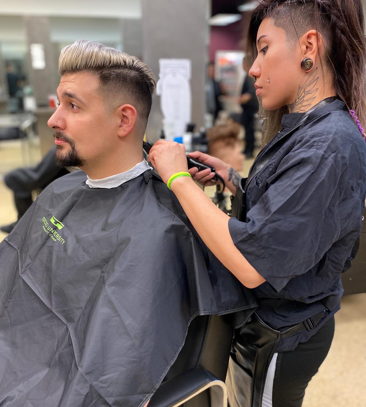 student cutting hair