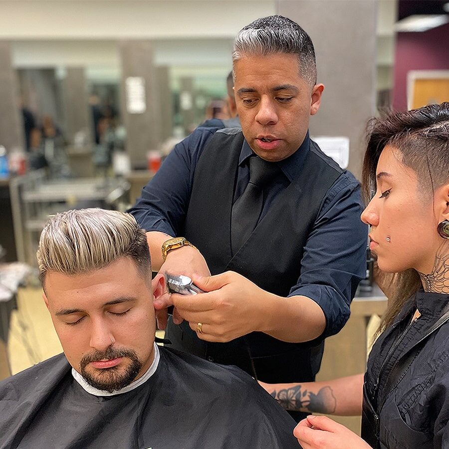 Tricoci Barber student learning to cut hair