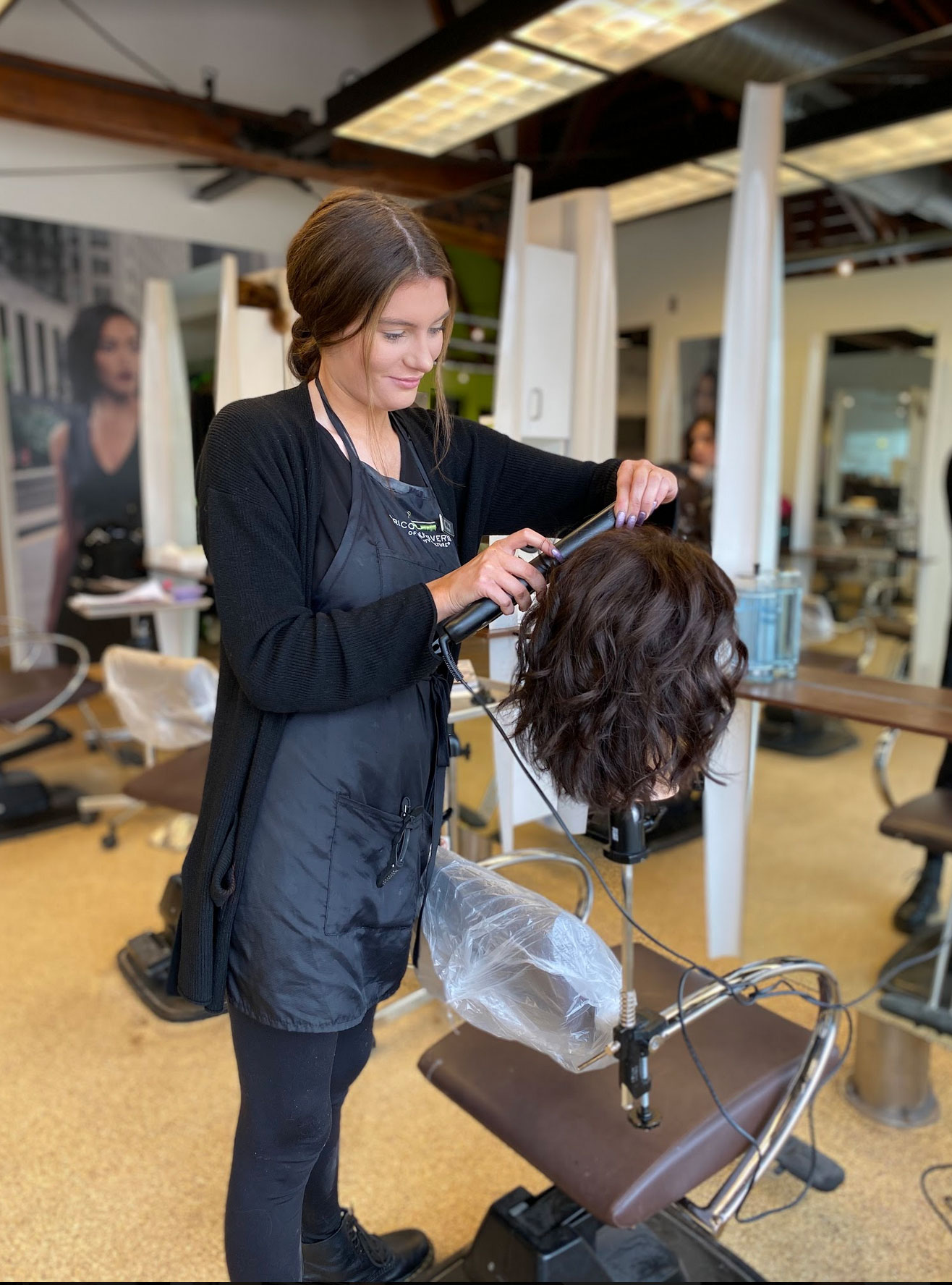 Tricoci University Student Cutting Mannequin's Hair