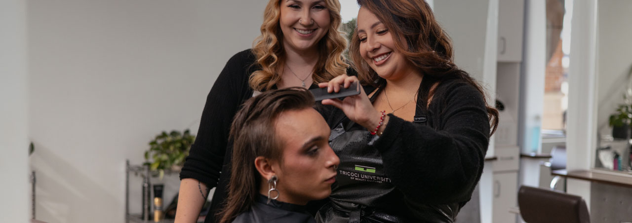 student cutting hair under teacher supervision