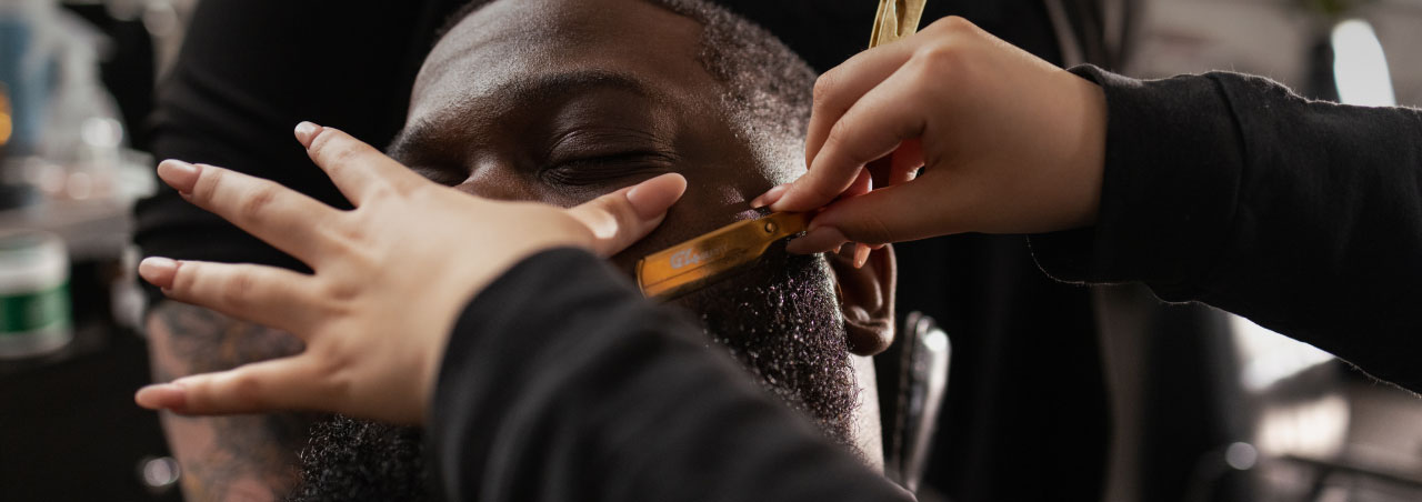 student trimming beard