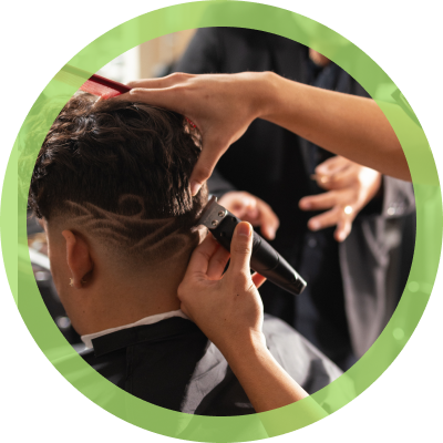 student cutting hair at barber school