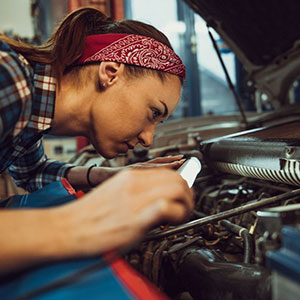 trade school student working on vehicle