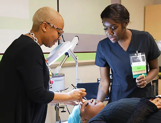 Tricoci student learning Esthetics from instructor