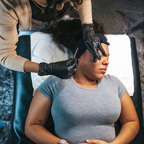 Woman receiving dermaplaning treatment